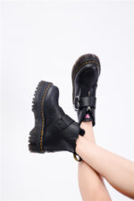 Black kawaii platform heart boots with chunky sole and decorative details.