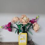 Kawaii juice box flowerpot featuring resin-made Lego roses and buds in a juice box container.