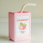 Kawaii juice box flowerpot, a pink resin replica of a strawberry milk juice box.