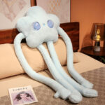 Blue long limb plushie with flowery star details, soft and cuddly.