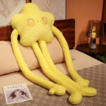 A yellow long limb plushie with star eyes and elongated arms, soft plush texture.