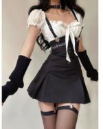 Woman wearing a korean aesthetic set, including a black skirt, white top, suspenders, and gloves.