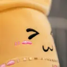 Close-up of a yellow bubble tea plushie with embroidered pink lips and a '7' and 'M'