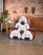 Kawaii onigiri plushie set displayed on a wooden surface.