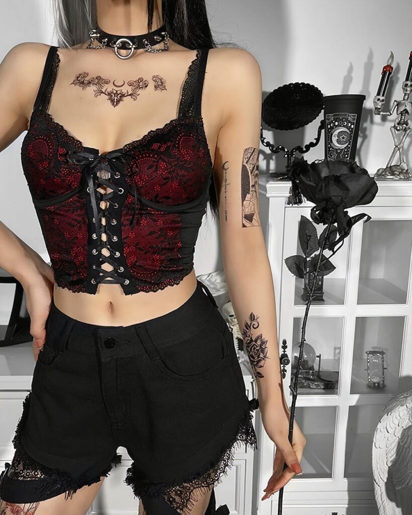 Red gothic lace vest with corset and black shorts, featuring intricate lacing details.