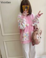 A pink harajuku hoodie with a cute, pastel design and fluffy accents.