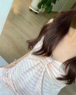 Japanese-Style Tank Top - Soft Girl Aesthetic, a light pink and white striped top worn by a person.