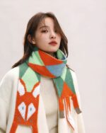 Cute fox scarf featuring a knitted fox design in pastel colors.