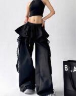 Black y2k cargo pants with a ruffled, layered design and lace trim.