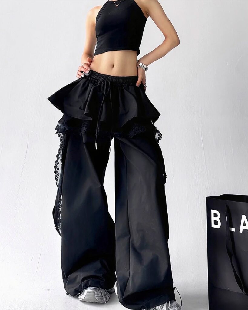 Black y2k cargo pants with a ruffled, layered design and lace trim.