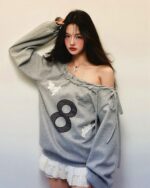 Gray coquette aesthetic sweatshirt worn by a model, featuring an off-shoulder design and floral embroidery.