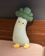 Long vegetable plushie, a soft, light green broccoli plush with yellow feet and face.