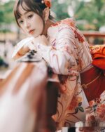 Woman wearing a summer anime yukata with floral print, Japanese aesthetic.