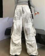 Washed out y2k artsy pants featuring a vintage-inspired print.