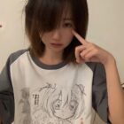 Close-up of a person wearing an animecore aesthetic shirt with a black and white illustration.