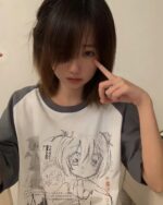 Close-up of a person wearing an animecore aesthetic shirt with a black and white illustration.