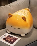 Close-up of a Nekopan bread cat plushie, a chonky orange cat toy.
