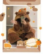 Person wearing brown kawaii animal pajamas with a hood, holding a phone.