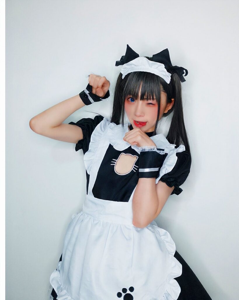 Person wearing a black and white cat maid cosplay outfit, featuring a cat ear headband and apron. Product: cat maid cosplay