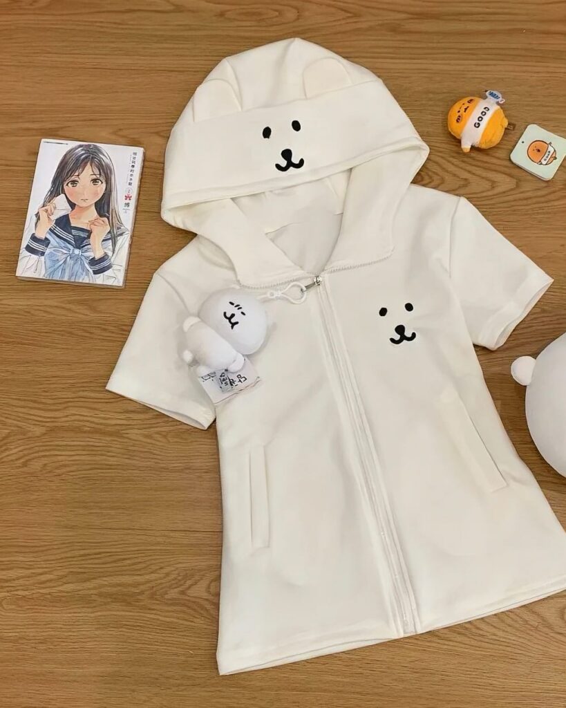 White jojifuku aesthetic hoodie with bear ears and a drawstring hood. It features a relaxed fit and pockets.