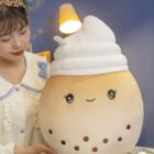 Cute brown bubble tea plushie with white topping and eyes.