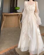 Cream French Style Long Sleeve Dress, featuring ruffled details and a flowy silhouette.