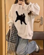 Oversize cat graphic sweater in cream, featuring a black cat print. Harajuku fashion style.