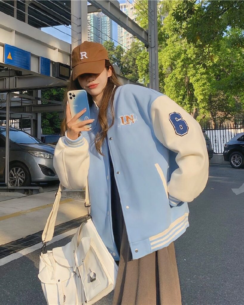 Korean aesthetic jacket worn by a person outdoors, featuring blue and white varsity style.