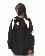 Black harajuku hoodie featuring feathered accents and star details. Loose fit, hooded sweatshirt.