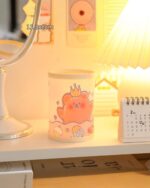 Kawaii pen holder featuring a cute pink cat design with accessories.