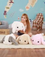 A set of big bunny plushies in white, pink, gray, and beige. Soft, floppy stuffed animals.