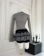 Dark gyaru set mockup featuring a grey ribbed long-sleeve top and a black and white striped ruffled skirt.
