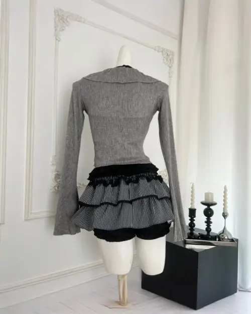 Dark gyaru set mockup featuring a grey ribbed long-sleeve top and a black and white striped ruffled skirt.