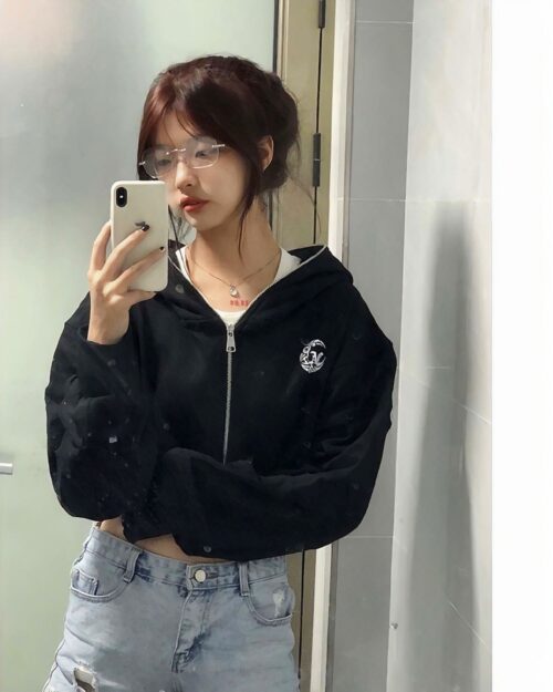 Black korean aesthetic hoodie worn by a person, featuring a zip-up front and a graphic design.