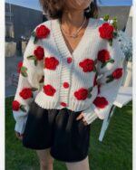 Thick knitted vintage aesthetic cardigan with red floral embroidery.