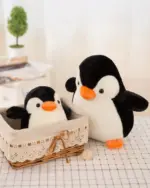 Pip the Chonky Penguin Plushie in a woven basket, soft and cuddly.