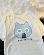 Neko Adventures kawaii cat t-shirt featuring a blue cat graphic and "THE MOON" text.