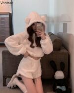 Model wearing white bear pajamas, fluffy hooded sweatshirt, and bunny slippers. Cute kawaii clothes outfit.