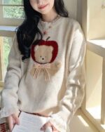 Cottagecore bear sweater featuring an apple and bow design, soft knit.