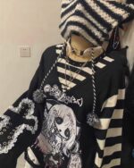 Black long-sleeved striped shirt with yami kawaii aesthetic print and lace details.