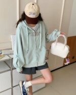 Romantic Long Island zipper hoodie worn with shorts and handbag.