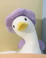 Kawaii Molly the Little Flower Duck, a white duck plushie toy with a purple hat.