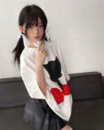 Model wearing an astro silhouette t-shirt with a black cat and red heart graphic.