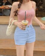 Pink bunny aesthetic top with floral print, worn by a woman.