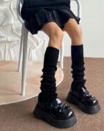 Black Japanese gyaru socks extending to the knees, paired with chunky platform shoes.