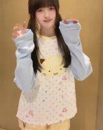 Jojifuku Harajuku cat sweatshirt featuring a cat face and polka dots, worn by a young woman.