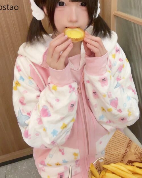 Person wearing a pink hoodie with kawaii animal prints. Harajuku pink hoodie.