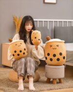 Cute bubble tea plushies, featuring a girl holding two plush drinks with tapioca pearls.