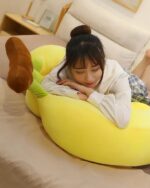 Cute yellow banana plushies in a three-pack, resting on a bed.