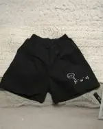 Black cotton shorts with kaomoji aesthetic print.